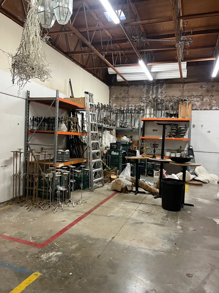Warehouse bay with shelving and junk before a cleanout